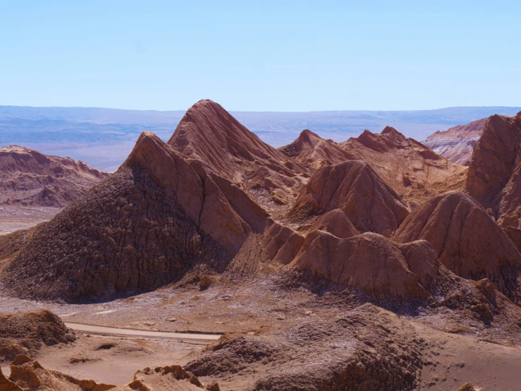 a group of rocky hills with a valley in the background