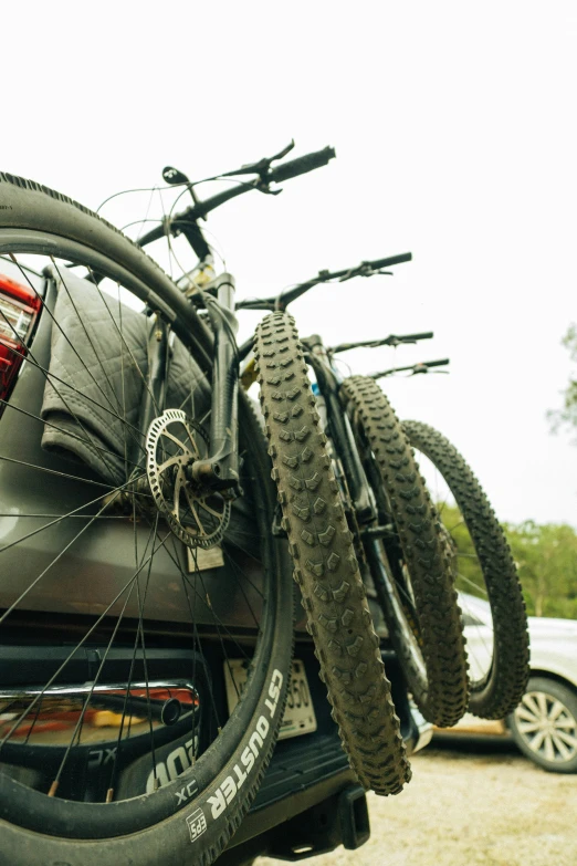 the bicycle is parked next to the vehicle in the parking lot