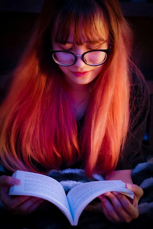 a woman with glasses reading a book