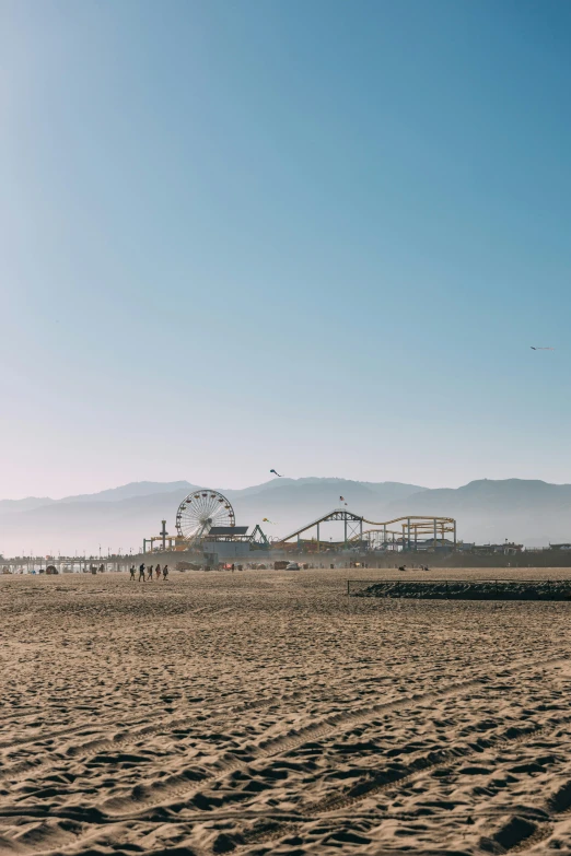 a beach with a large ferris wheel and amut park