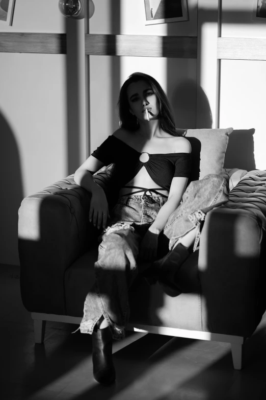 black and white pograph of woman sitting on a chair