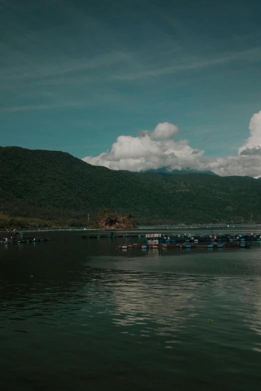 a lake in front of mountains and a bridge