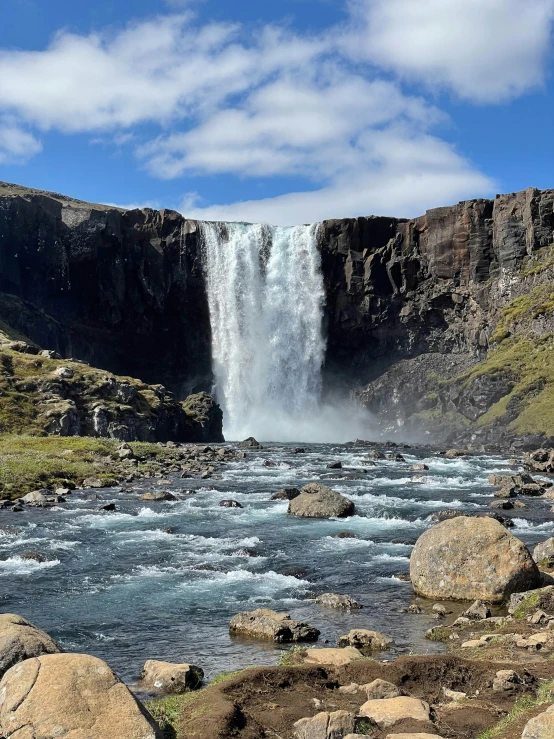 a view from below a high waterfall looking over the river