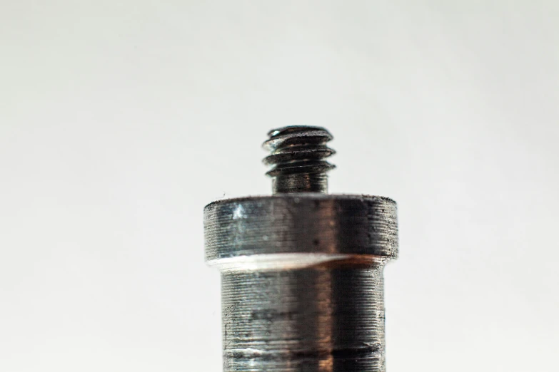 a glass bottle with metal caps and screws