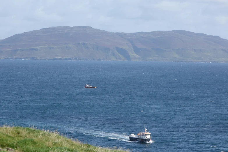 a motor boat drives near another boat out on the water