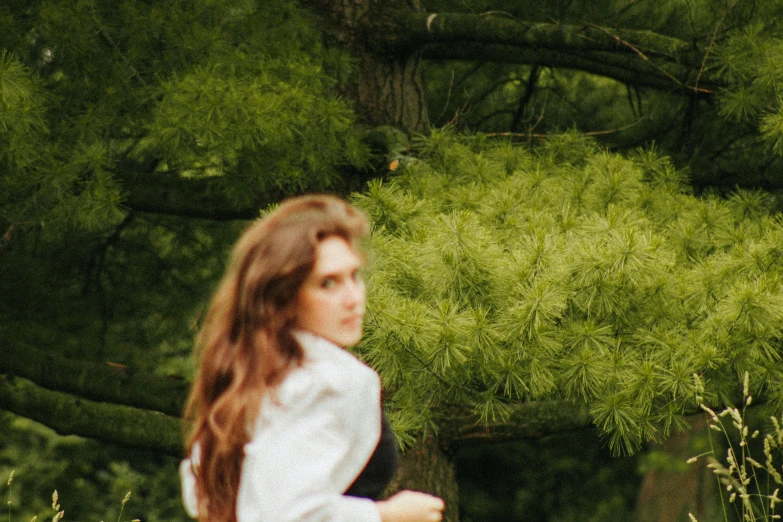 a woman wearing a white shirt and blue jeans