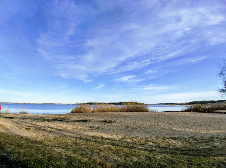 an open air field with a body of water