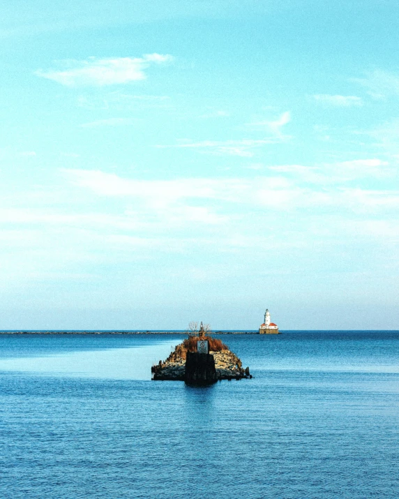 a small ship sailing on the sea between two large structures