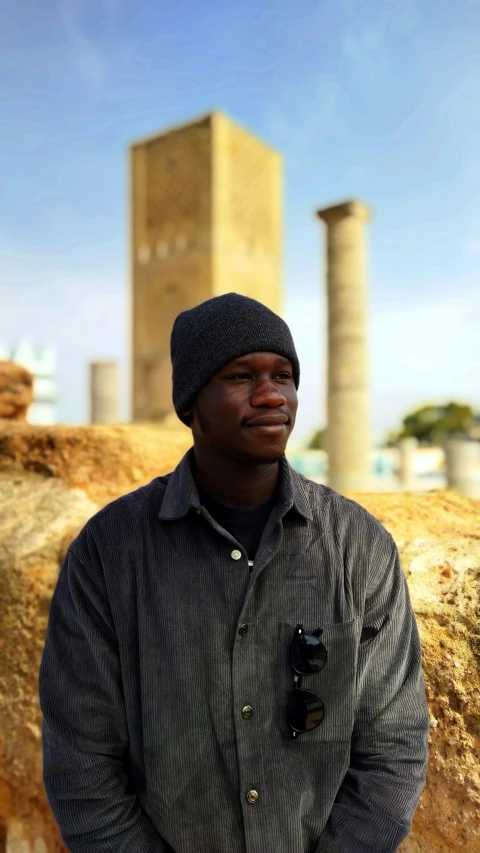 a man in a hat posing for a picture