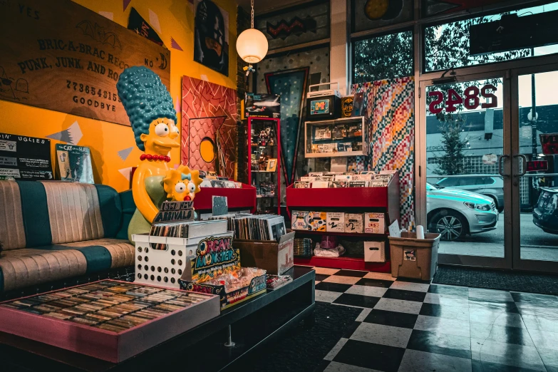 a room filled with furniture and a wall with posters on it