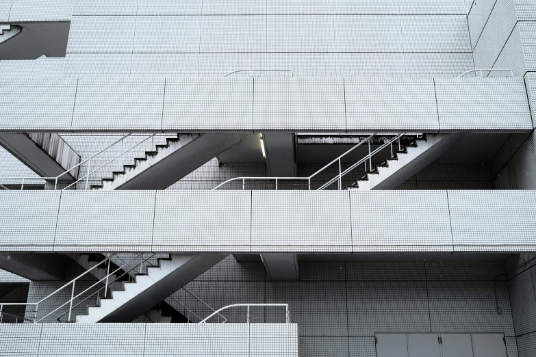 two metal stairs going through an empty space