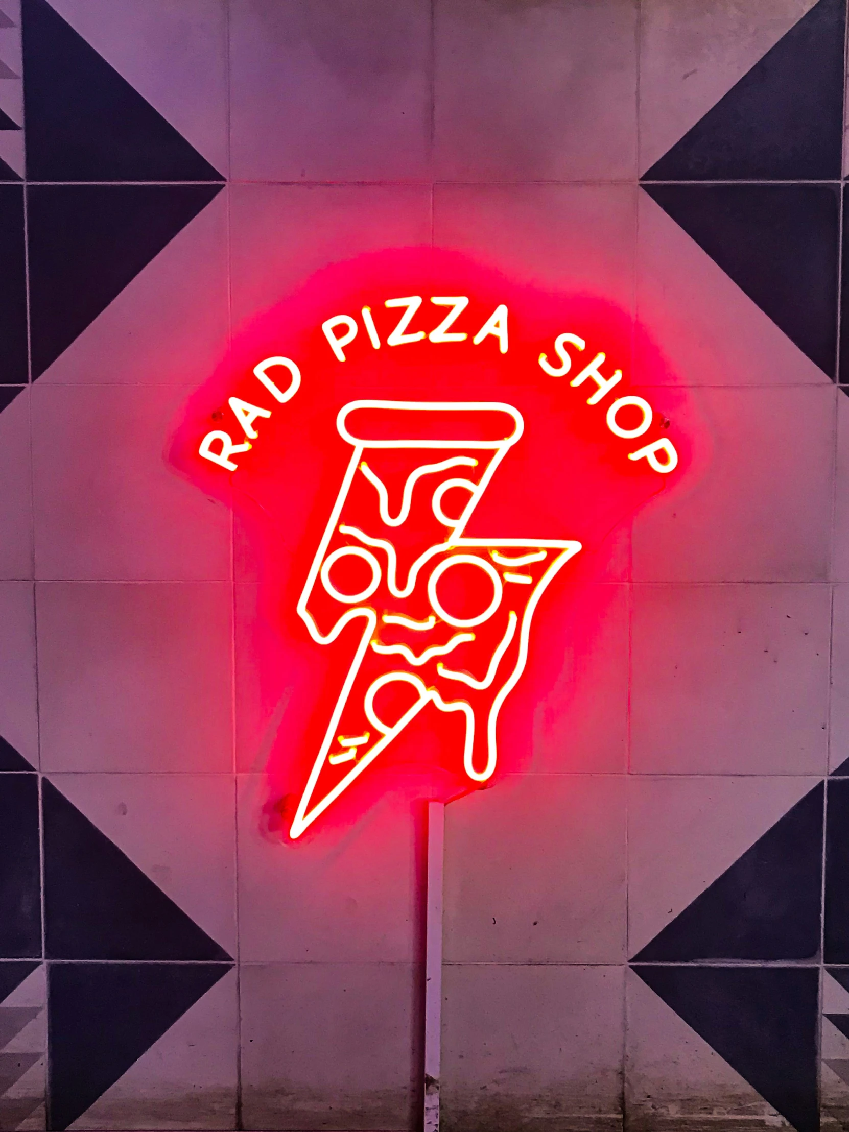 a sign in the shape of a pizza is displayed