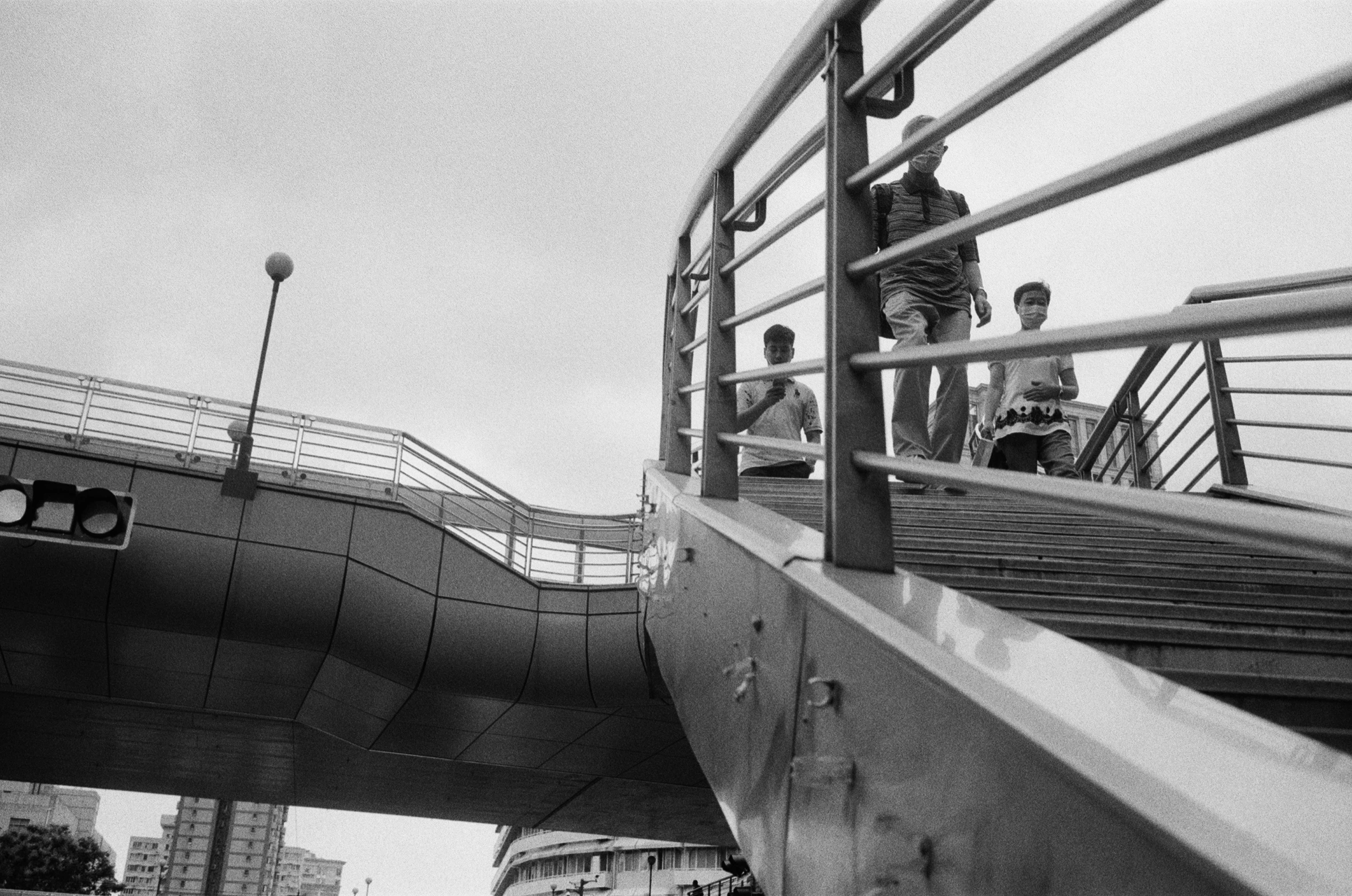 a group of young people are standing on the bridge