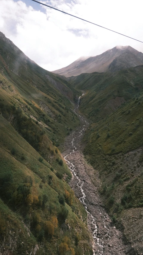 the mountain is surrounded by greenery and rocks