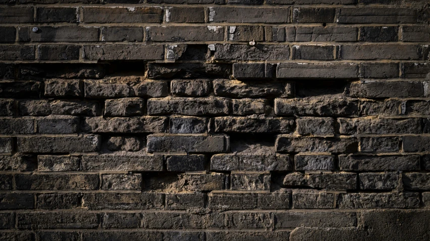 a close up of the brick wall with the light at the end