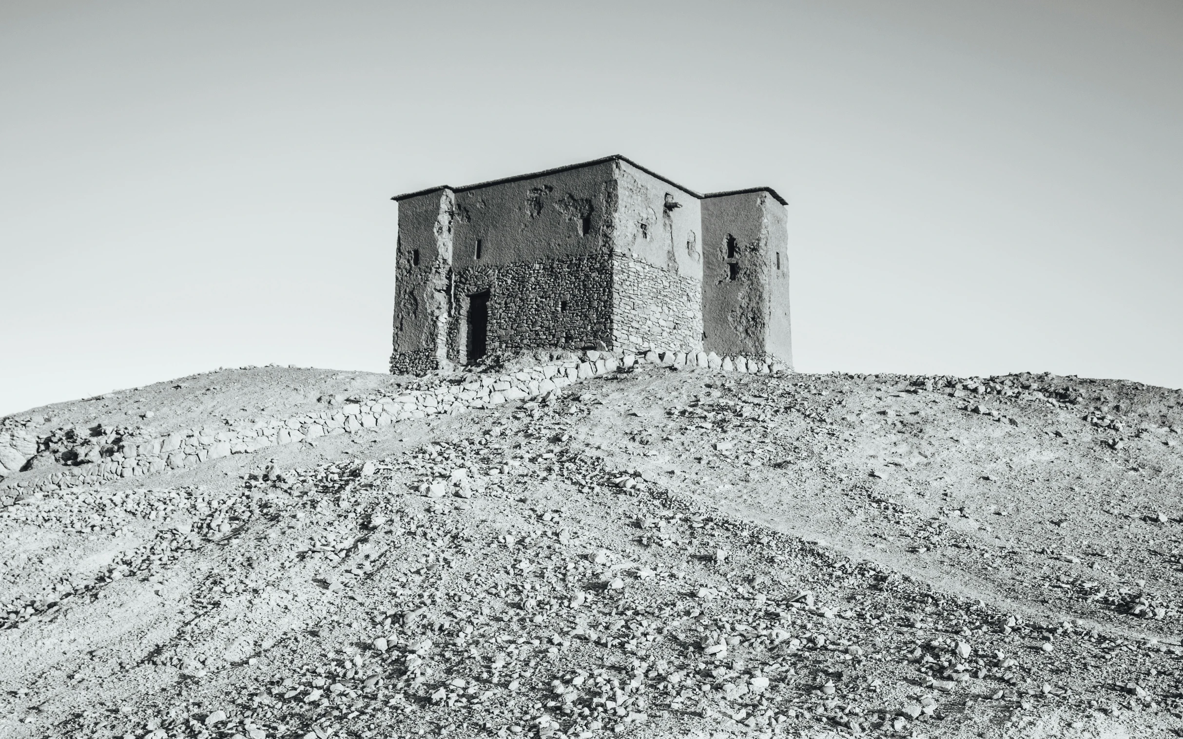 two stone structures with trees on top of it