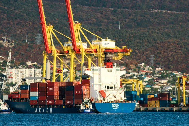 an image of containers and cranes at a port