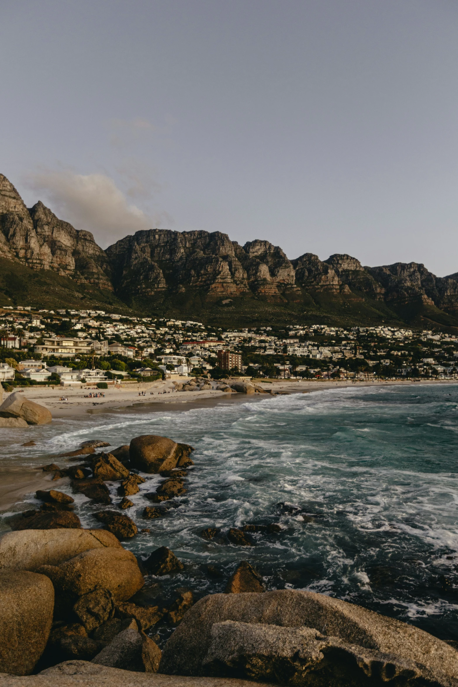 a rocky beach and blue water on a sunny day