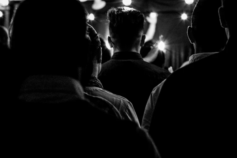 a group of people in dark room lit with lamps