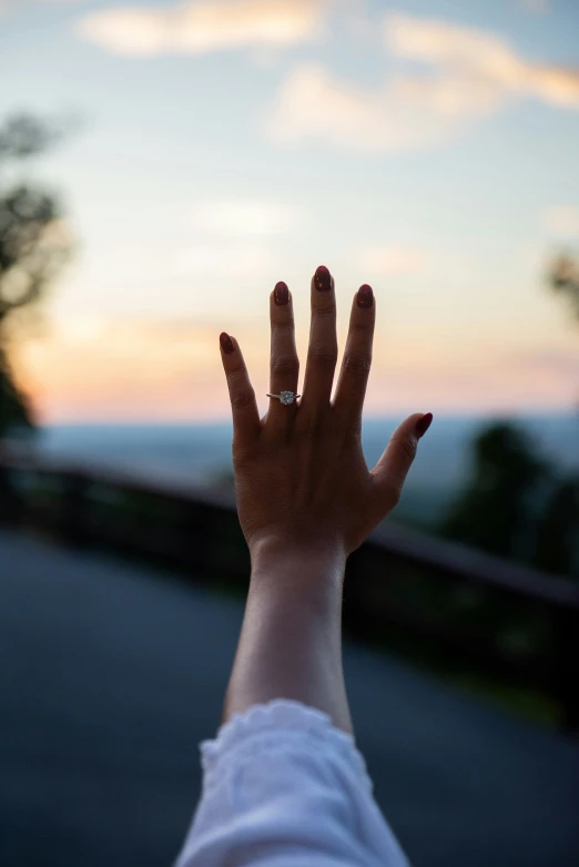 someone holds their hand up to the sky