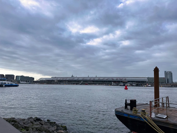 a dock with boats and buildings by the water