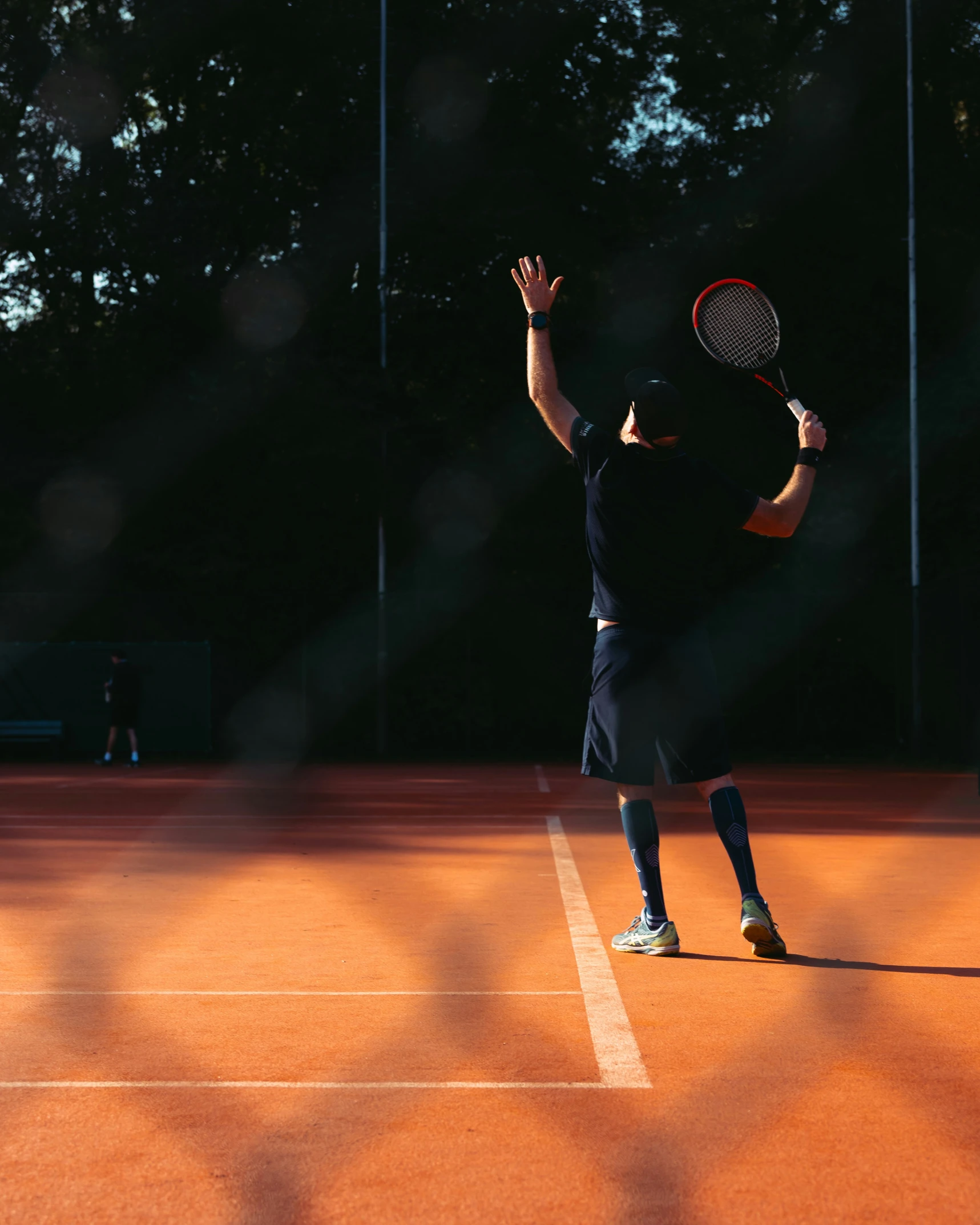 a man standing on top of a tennis court holding a racquet