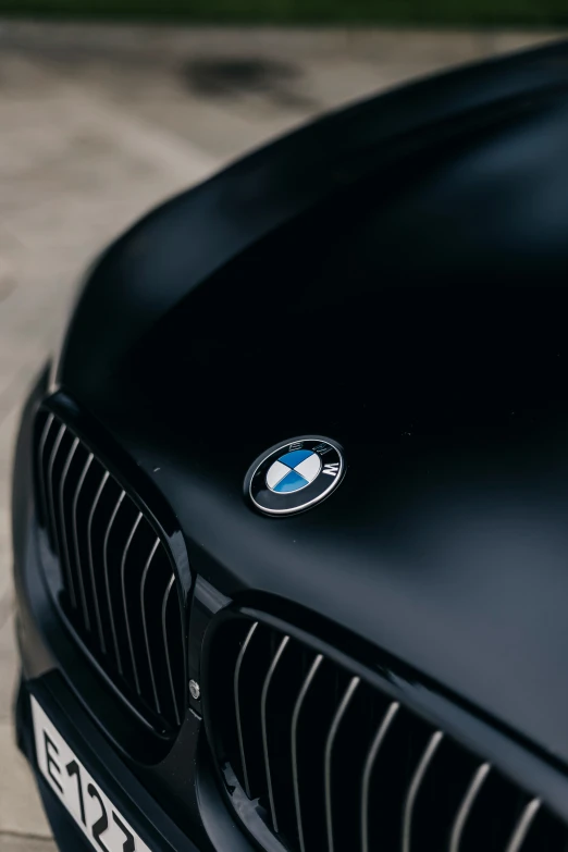 the front end of a black bmw sports car