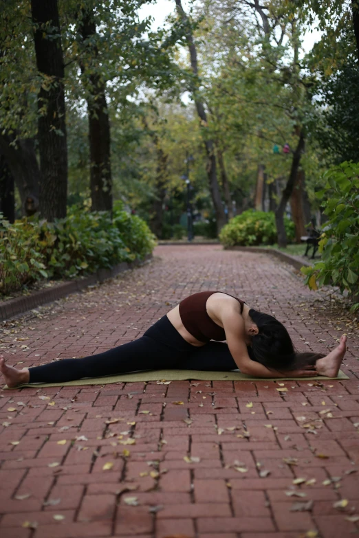 woman practicing yoga and meditation on a pathway