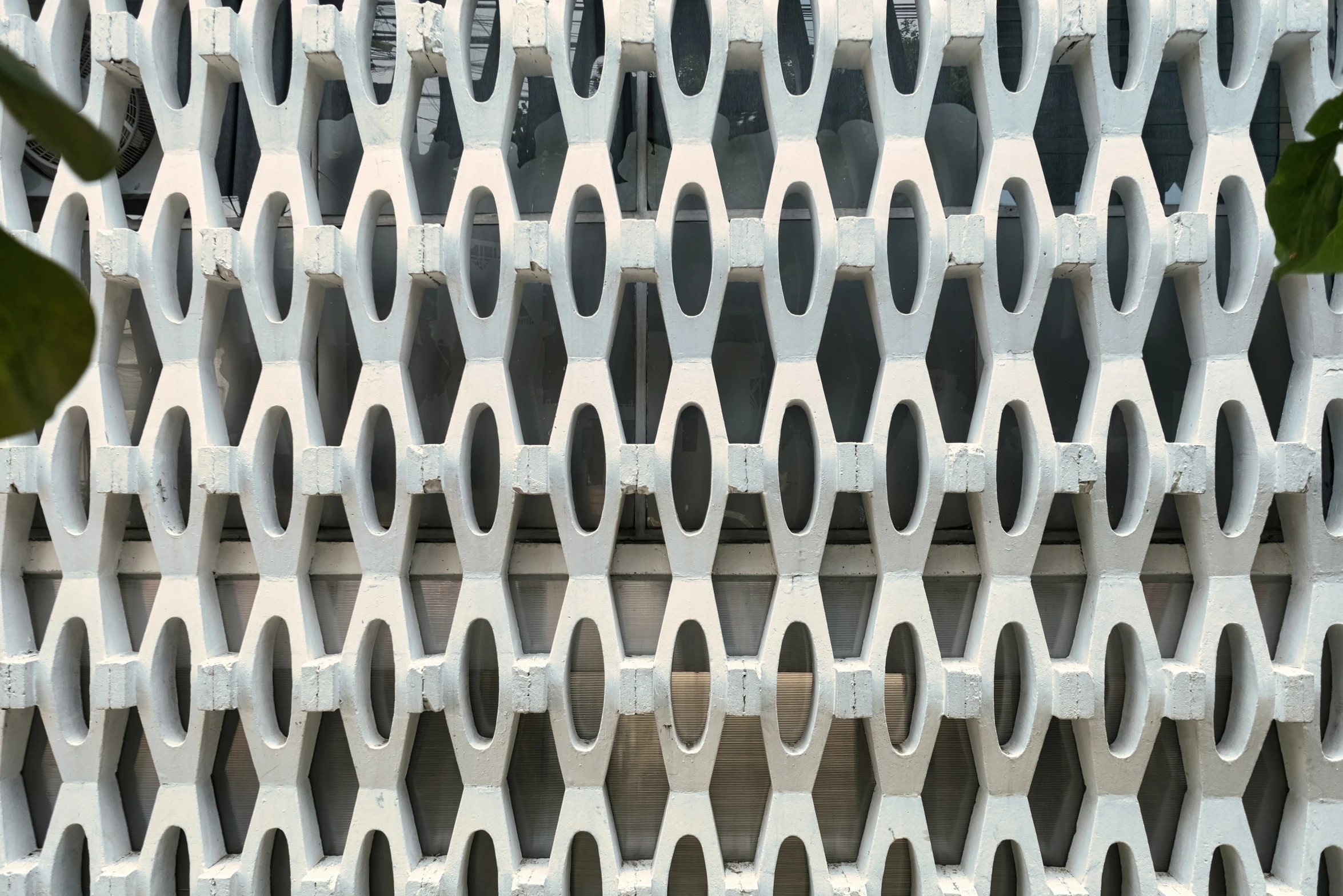 a large white building with vertical dividers and planters