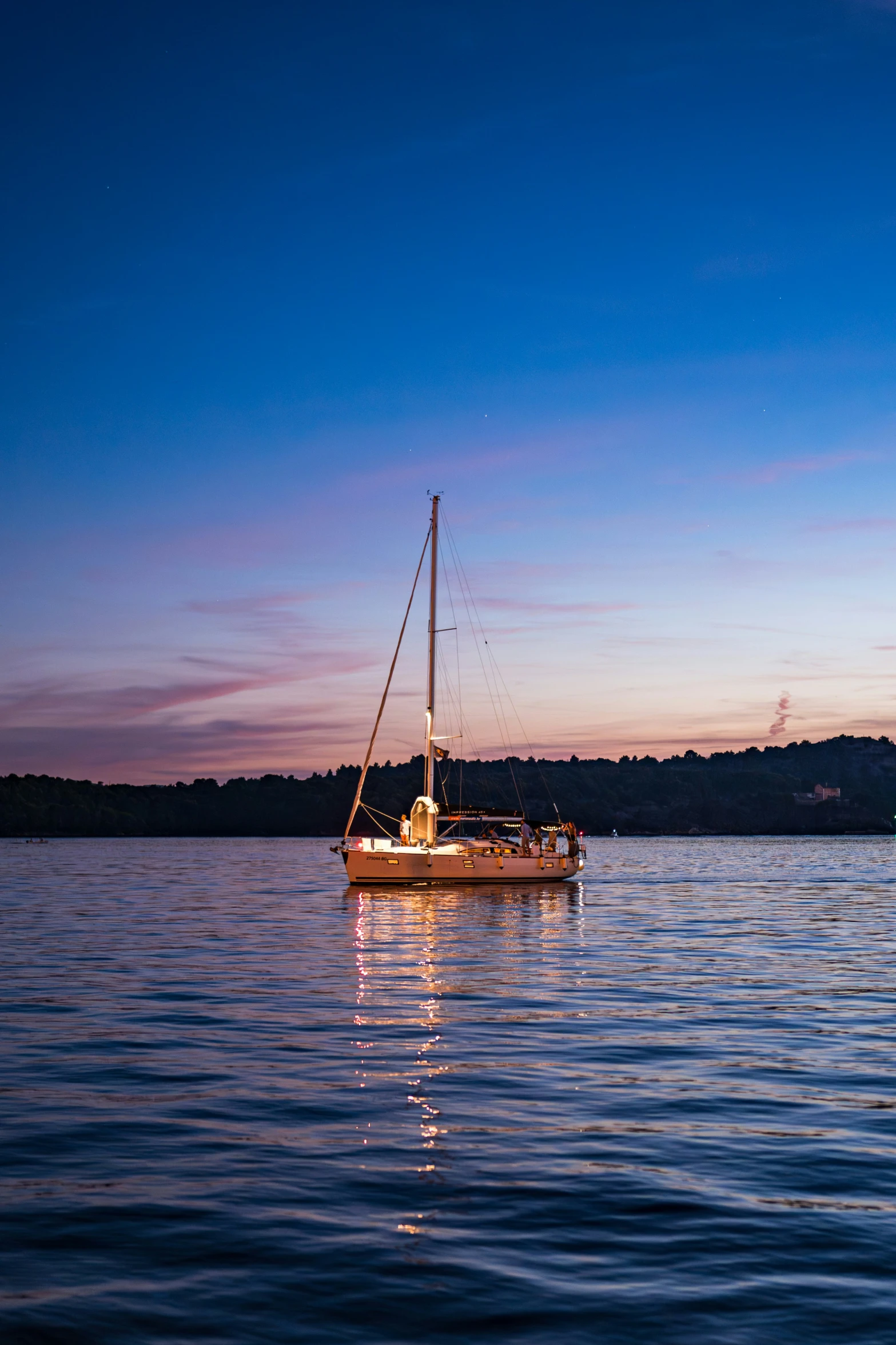 an old boat in the water during sunset