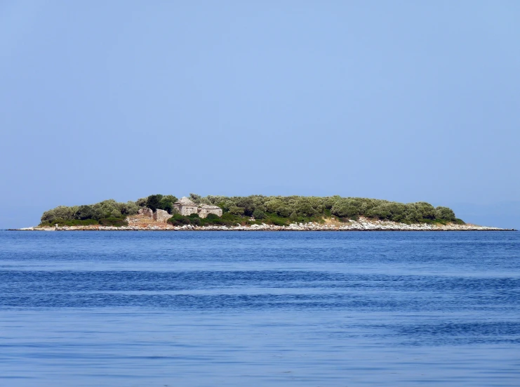 small island with trees on an empty peninsula