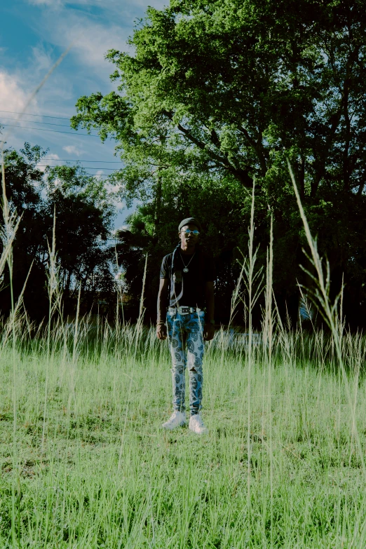 a man is standing in the middle of tall grass