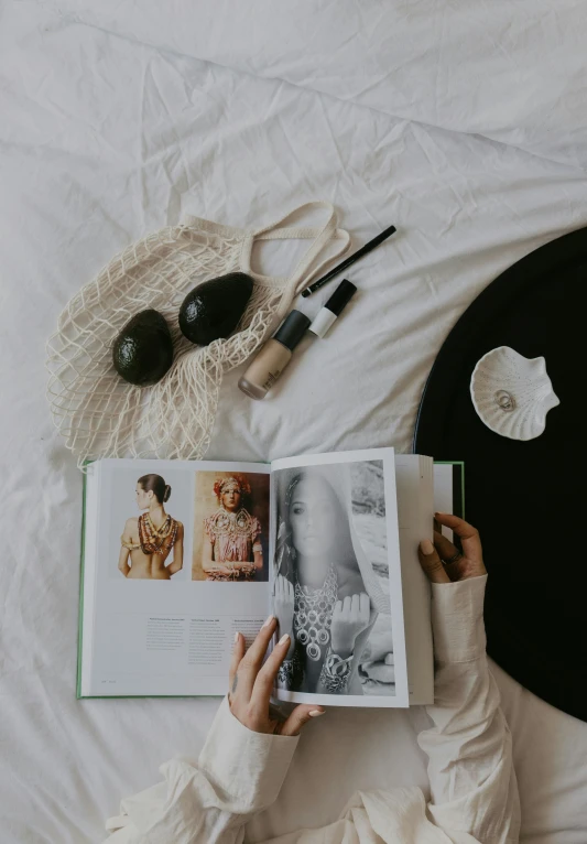 someone is reading a book while lying in bed