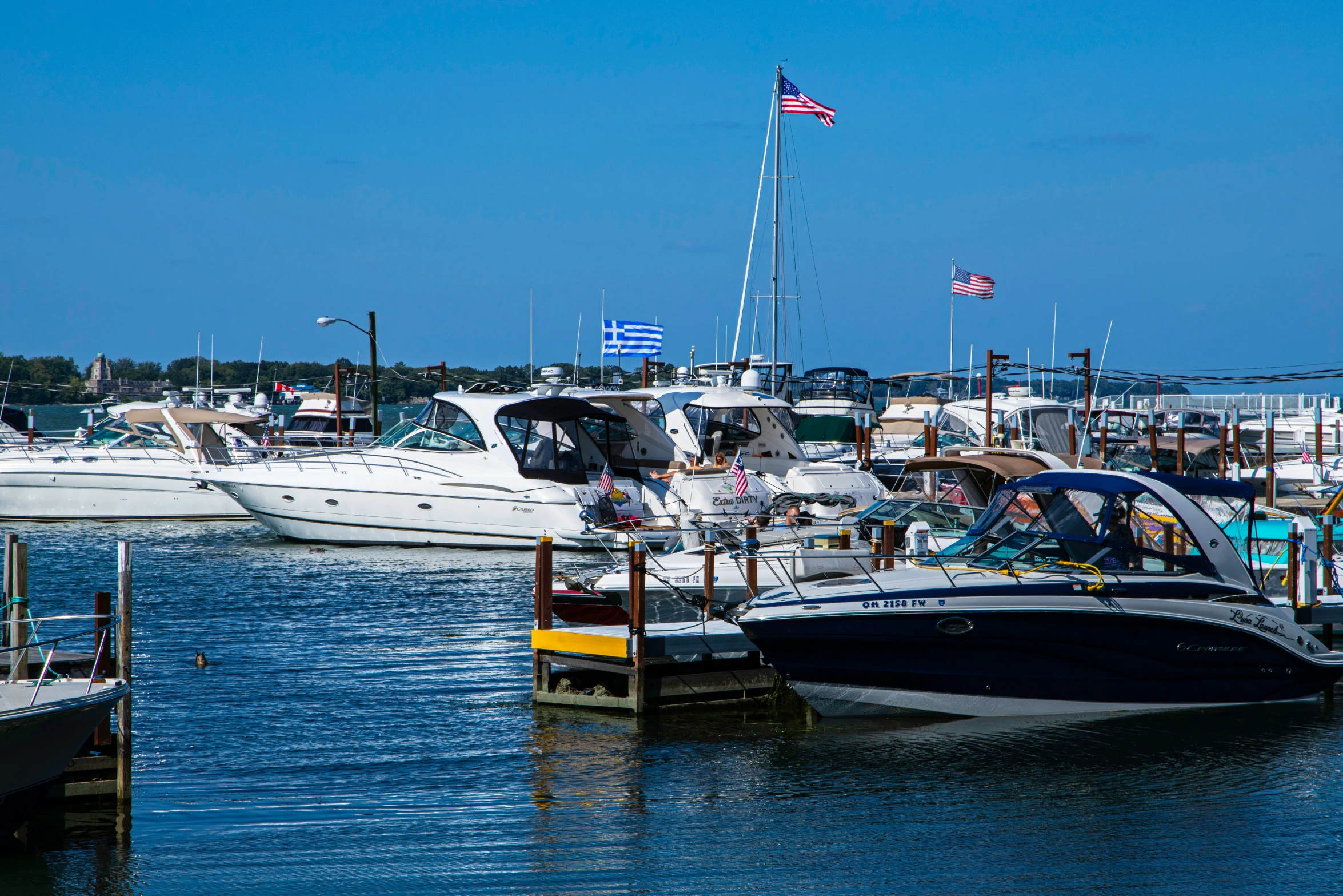 boats docked on the water in a small harbor