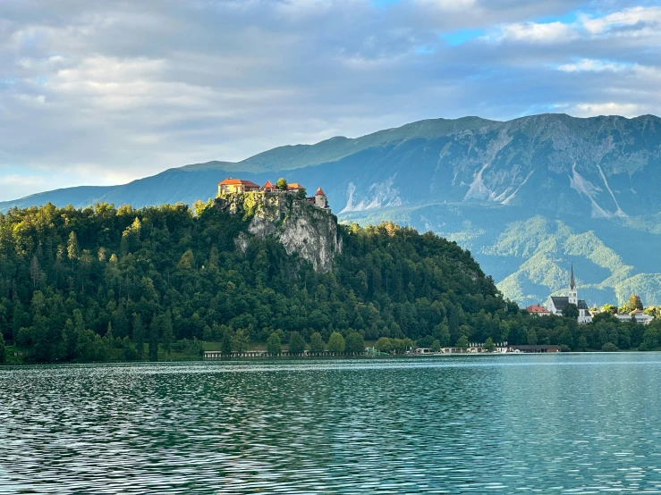 a castle on a mountain in the middle of a lake