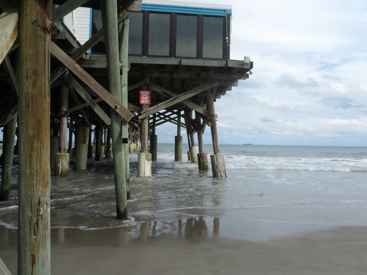 a pier is shown on a sandy beach
