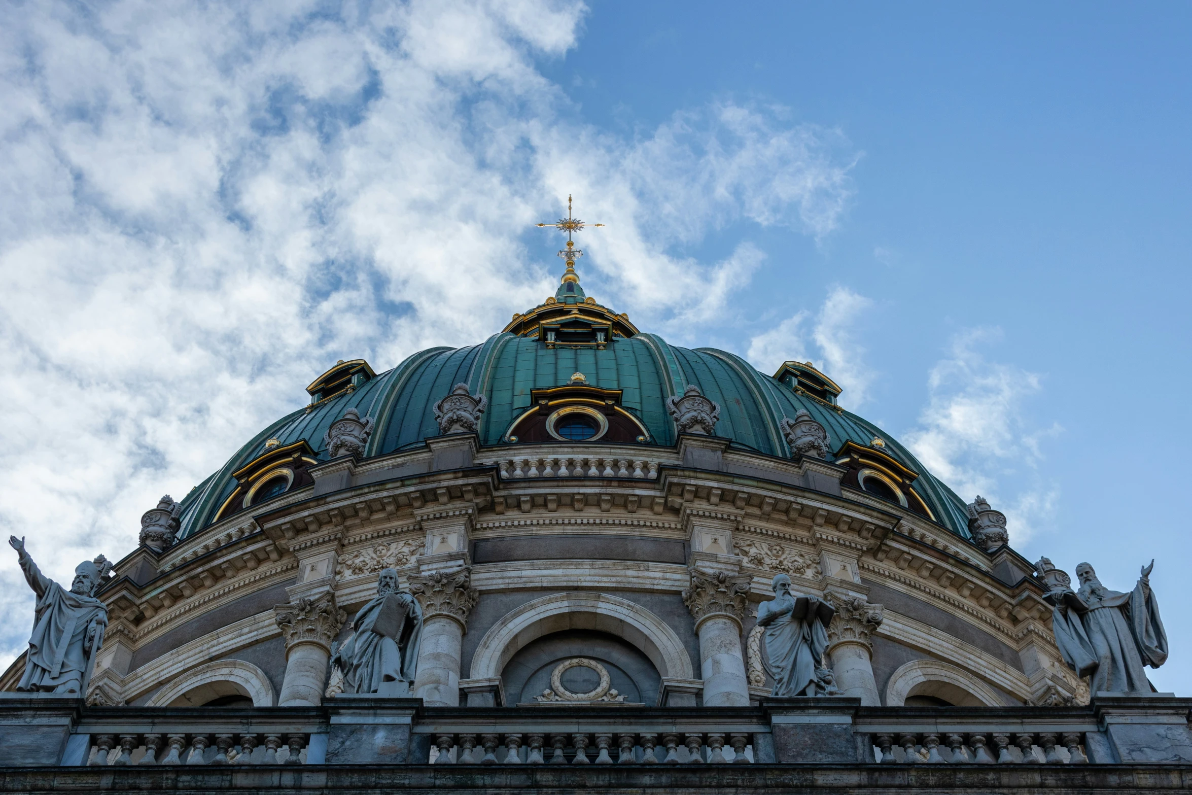 an old church with a dome and cross in the center