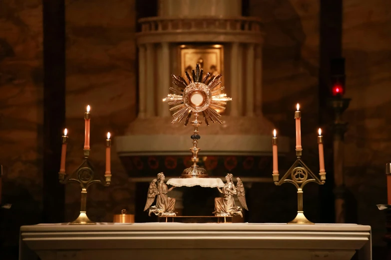 a cathedral alter with candles lit up during a service