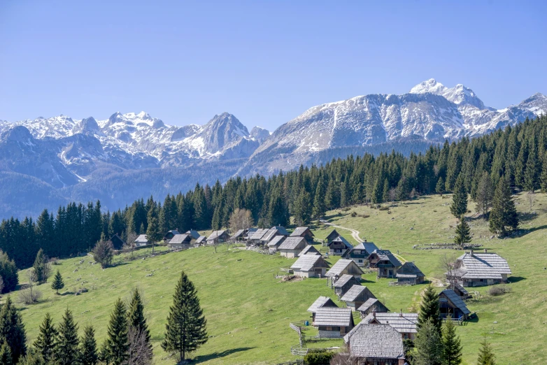 a village of cottages on a hill in the mountains