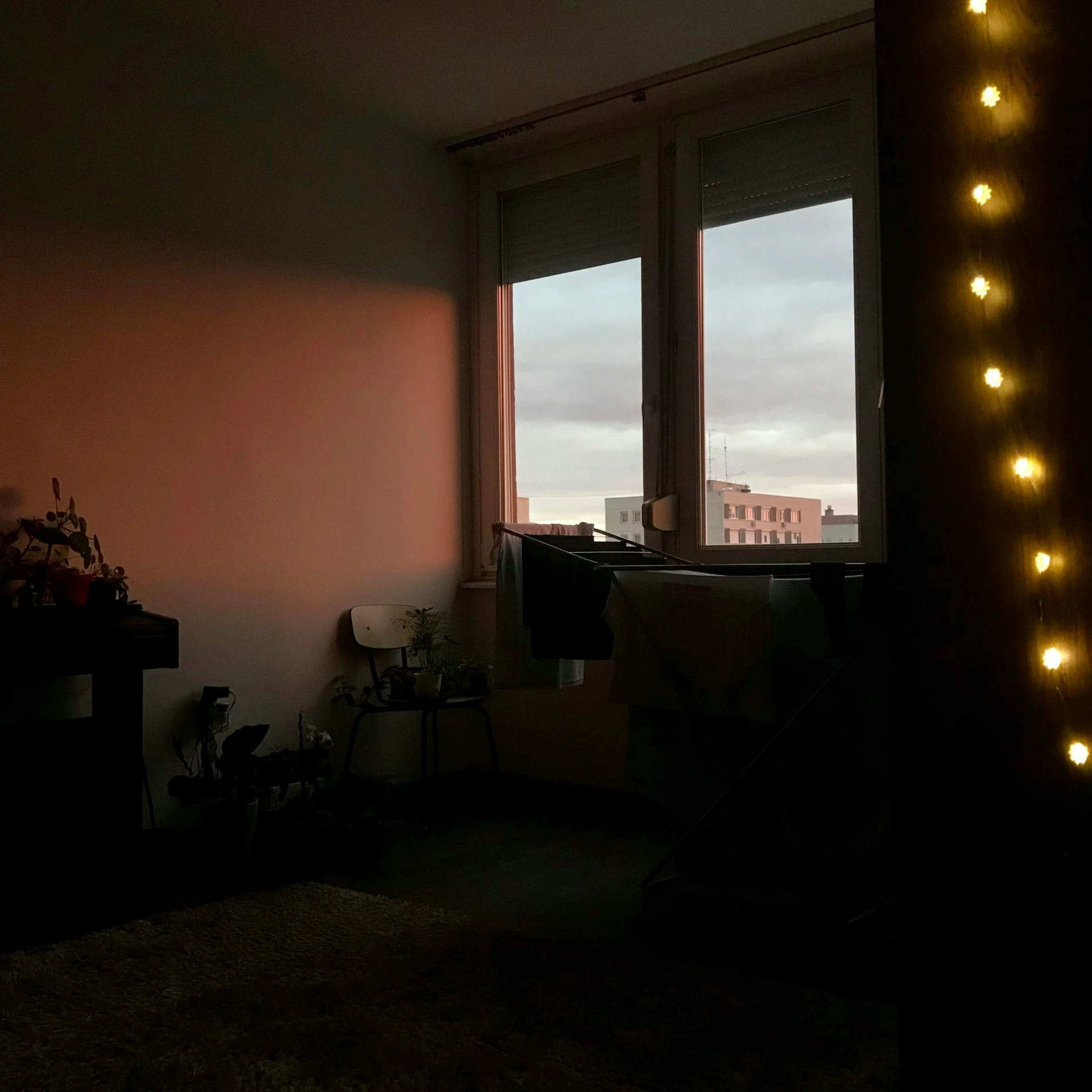 the lights on a window can be seen in this dim room