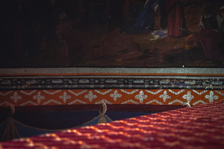 a cat laying on a red carpeted bed