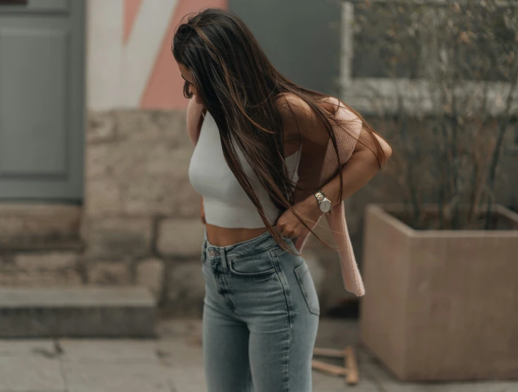 a woman standing on the street talking on her cell phone