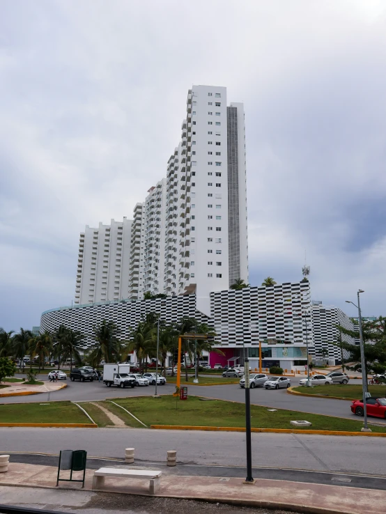 a city view of a building with a parking lot below it