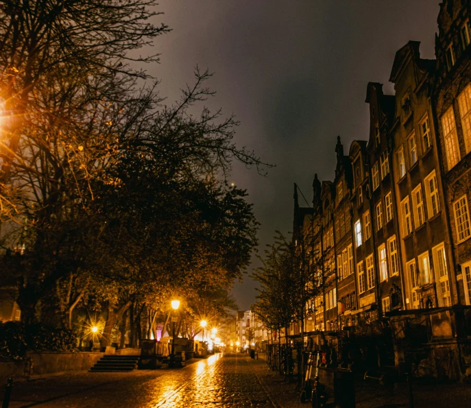 a dark night on a small street in the rain