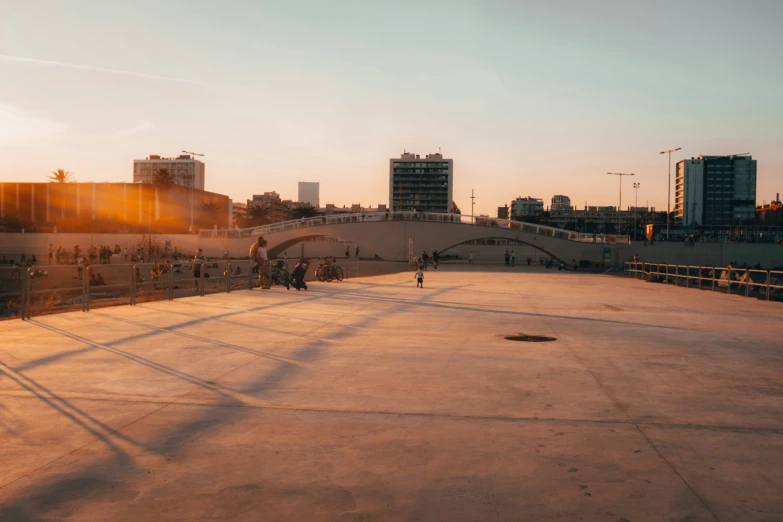 people walking along a boardwalk in front of some buildings