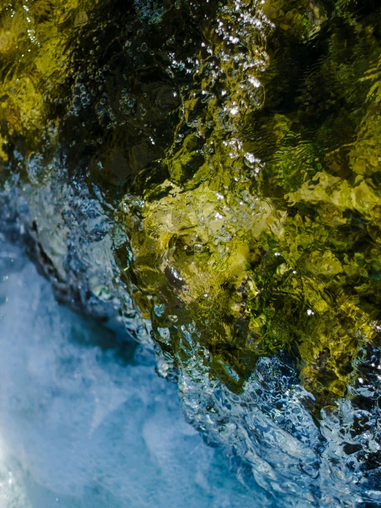 a large body of water that is under some rocks