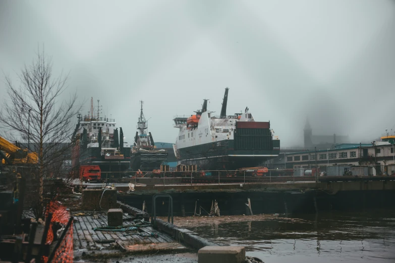 a large ship is docked near some docks