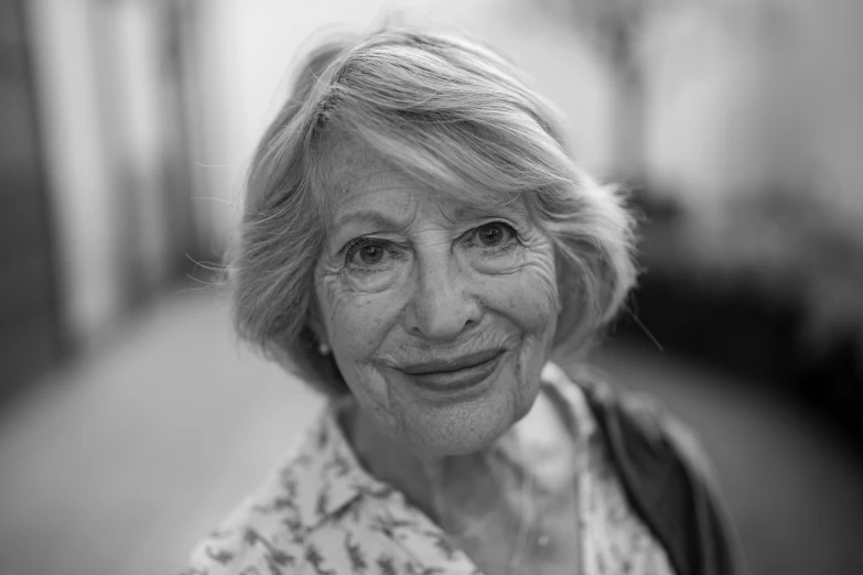 a black and white po of a woman smiling for the camera