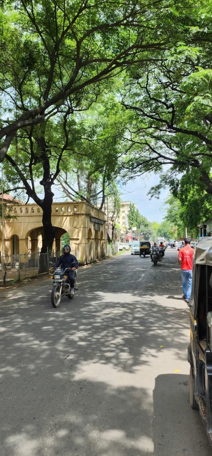 a man riding a motorcycle on the side of a road