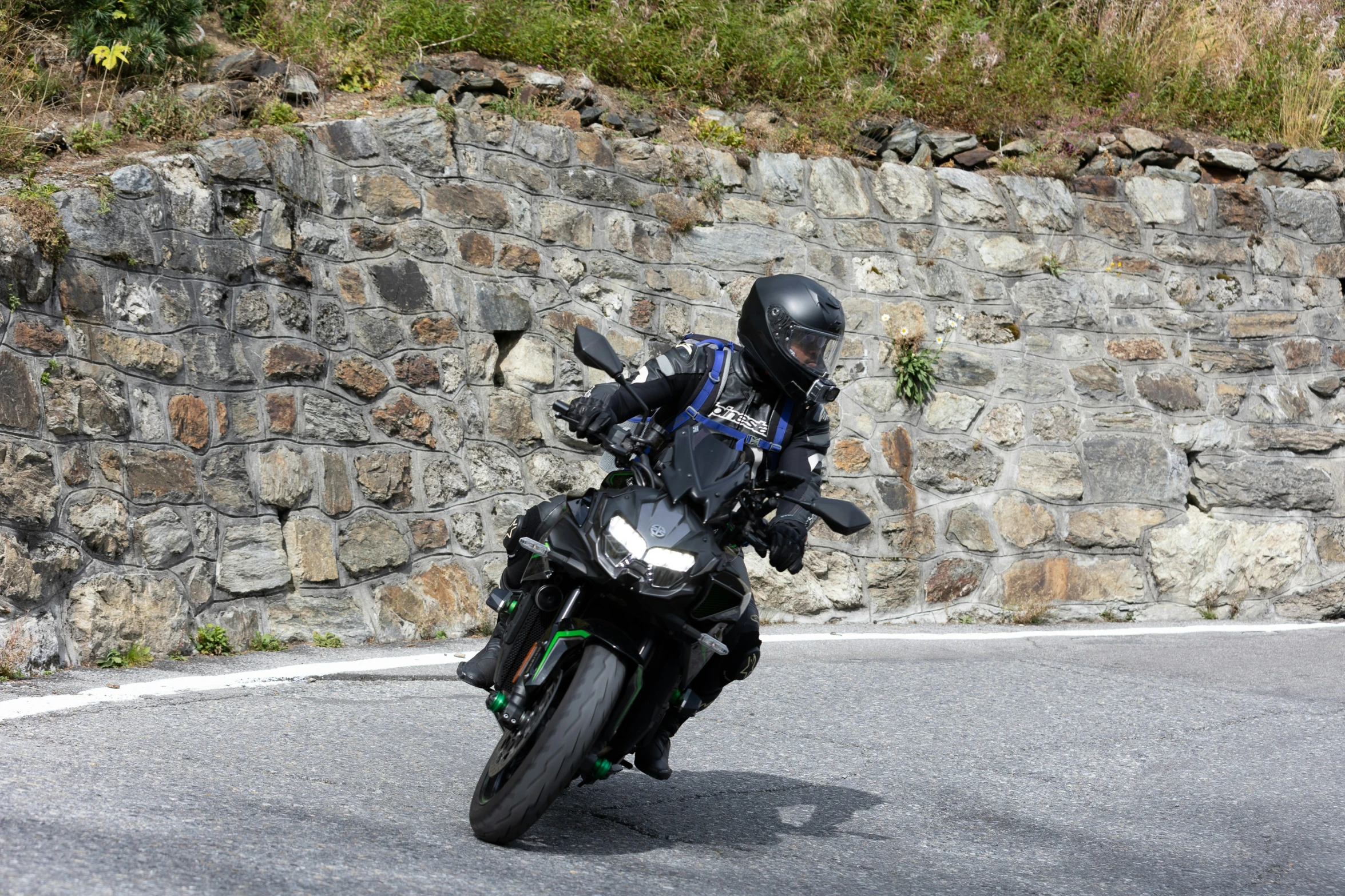 a person on a black motorcycle leaning into a curve